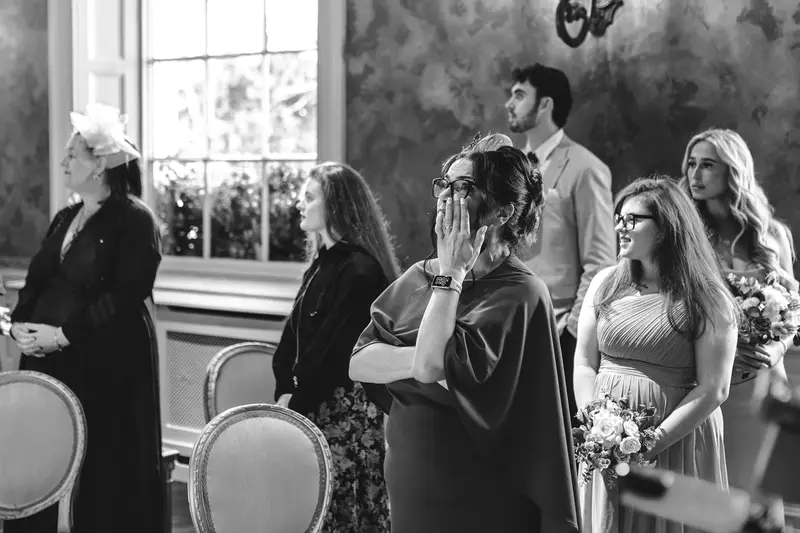 Emotional wedding guests reacting during the ceremony, captured in documentary wedding photography