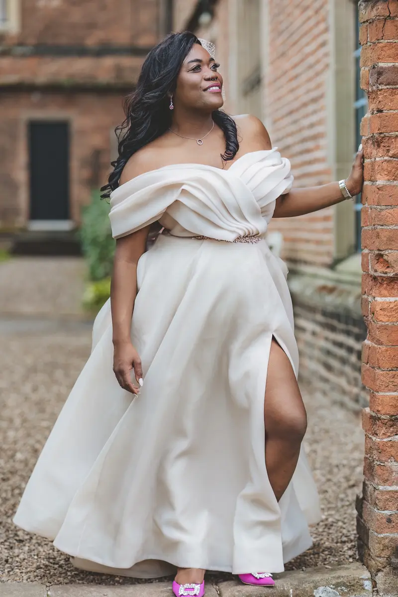 Bride smiling during relaxed outdoor bridal portraits at the wedding venue