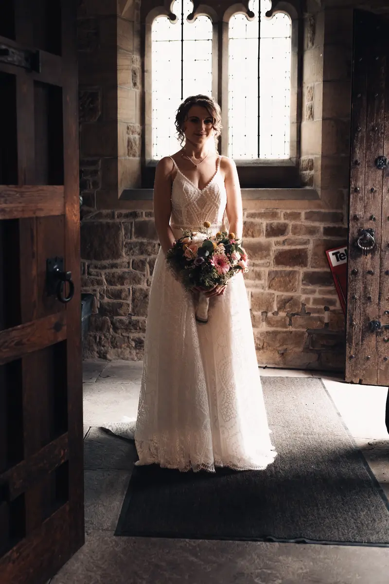 Moody bridal portrait inside church entrance photographed by Yorkshire wedding photographer