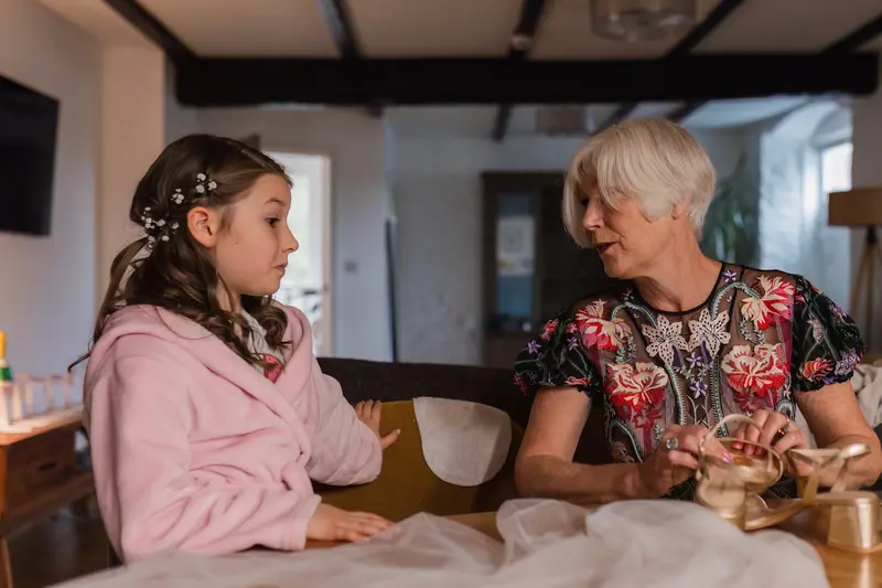 Emotional documentary wedding morning moment between flower girl and grandmother in Yorkshire