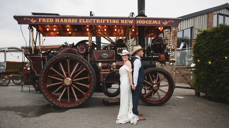 Documentary wedding couple photo with rustic steam fair ride