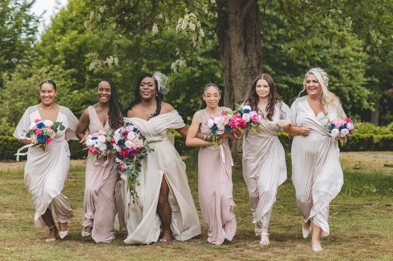 Bridal party walking together outdoors during fun documentary wedding photography