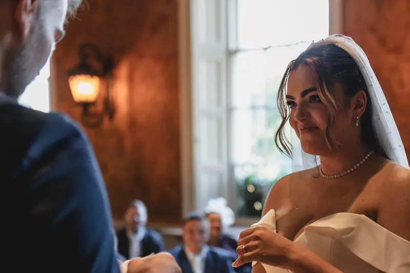 Emotional bride listening to vows during Yorkshire wedding ceremony