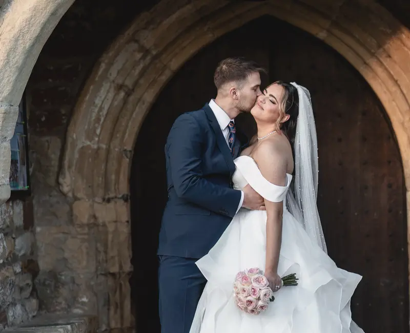 Candid wedding kiss captured by documentary wedding photographer in Leeds