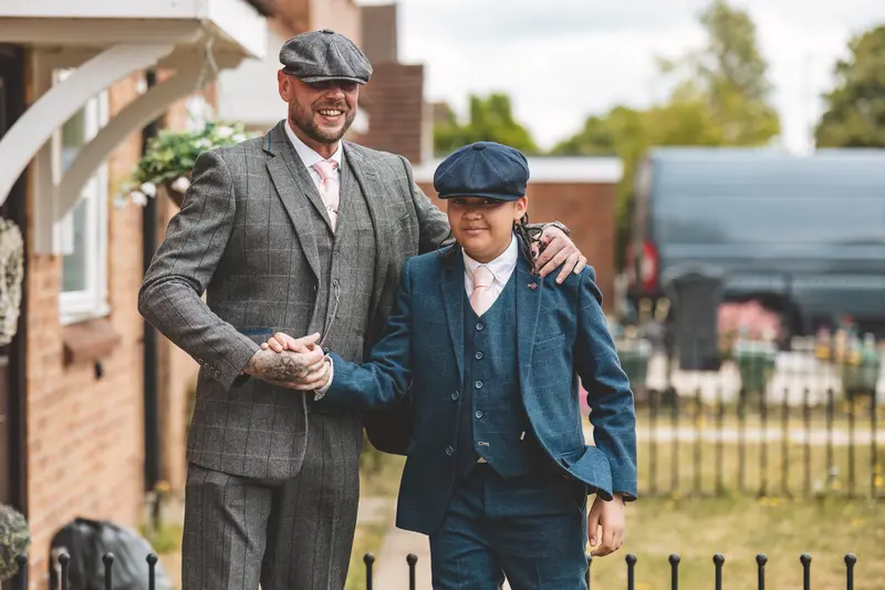 Groom and young boy walking together before the wedding ceremony