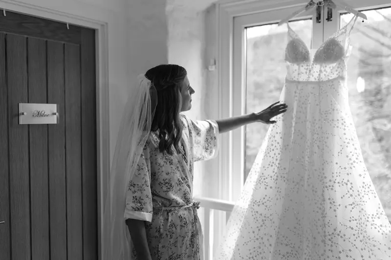 Black and white bridal portrait with wedding dress during morning preparations