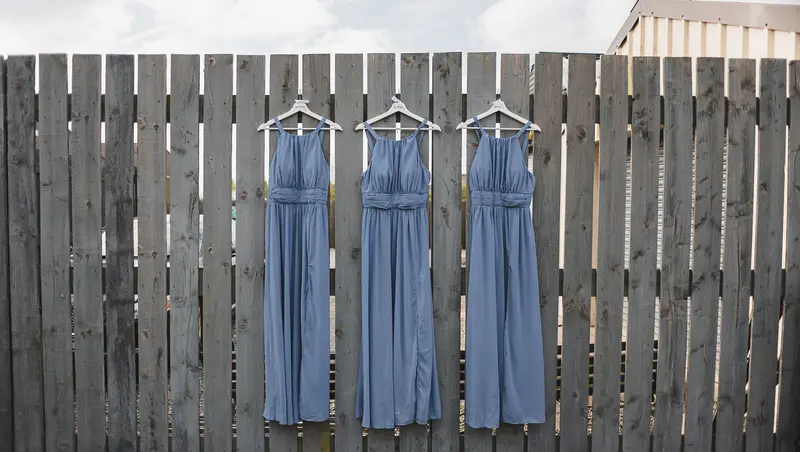 Blue bridesmaid dresses hanging before Yorkshire wedding ceremony