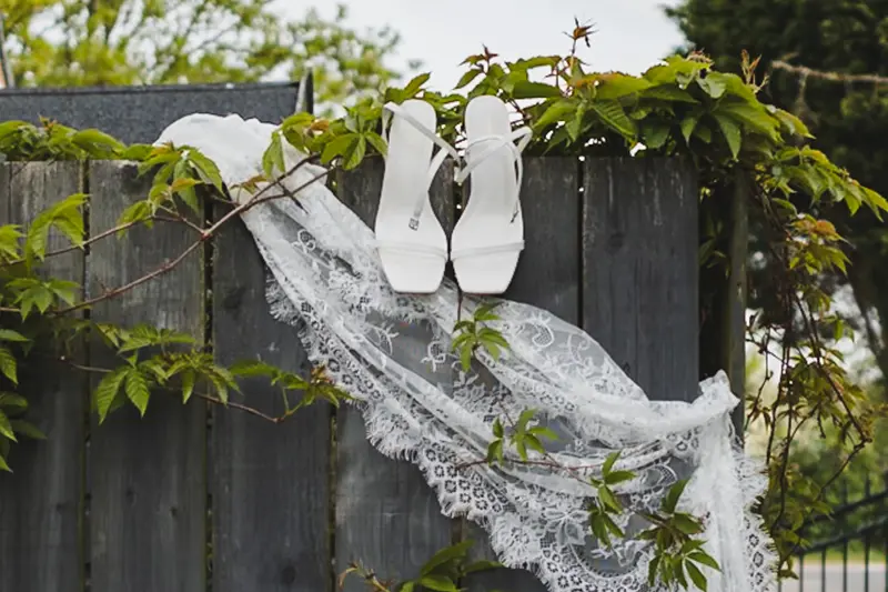Bridal shoes and lace veil detail at documentary Yorkshire wedding