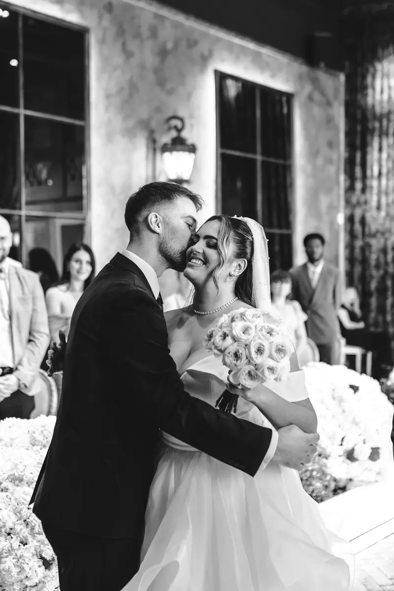 Emotional black and white wedding first kiss during intimate ceremony