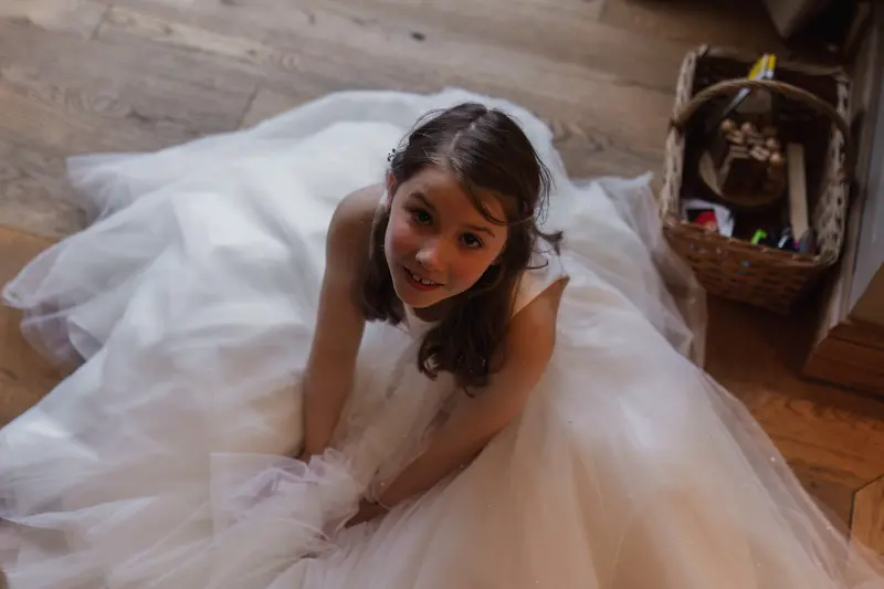 Natural flower girl portrait during bridal preparations at rustic Yorkshire wedding venue