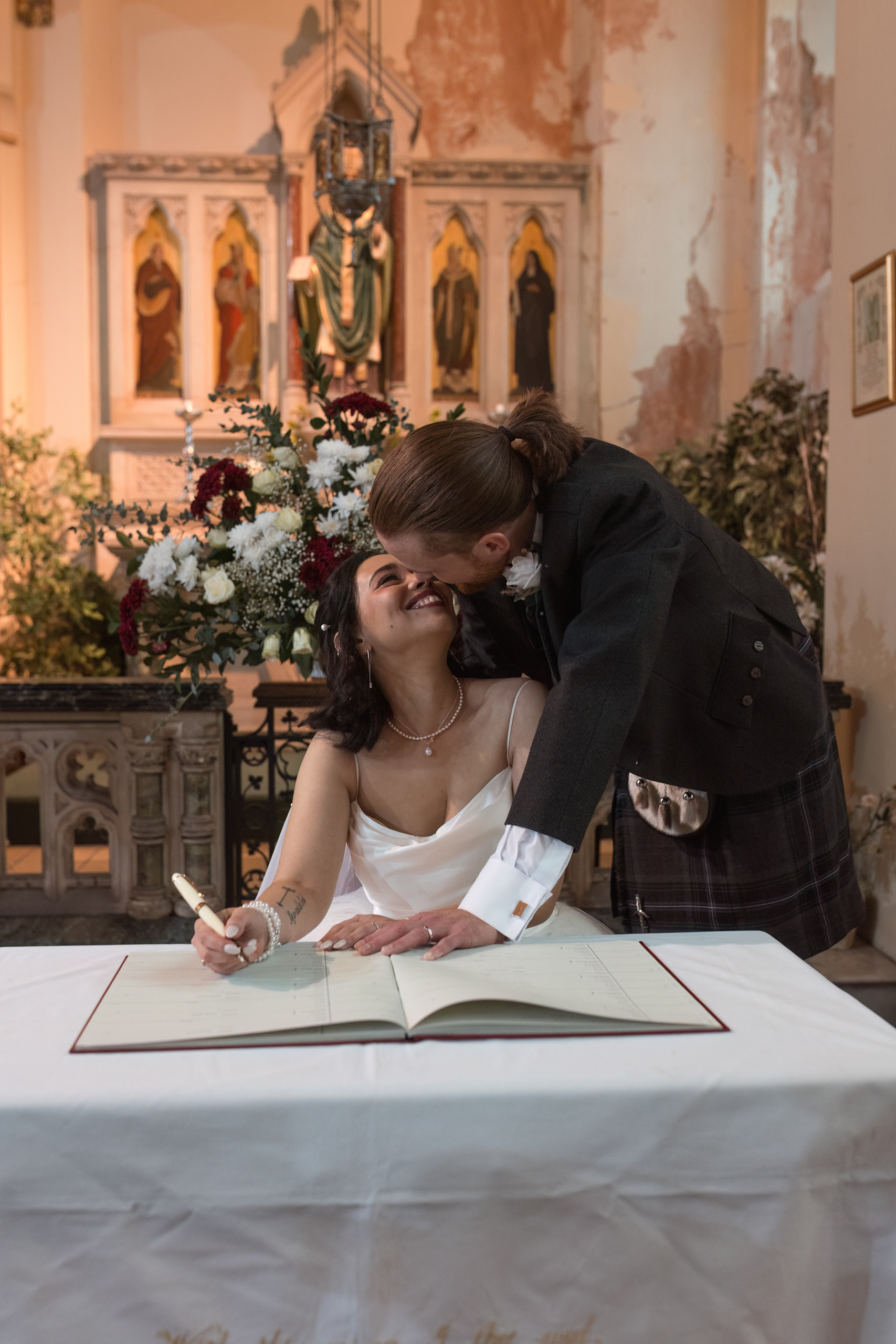 Documentary wedding photography Yorkshire capturing candid signing register moment with bride and groom