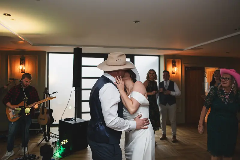 Emotional wedding kiss during first dance with live wedding band