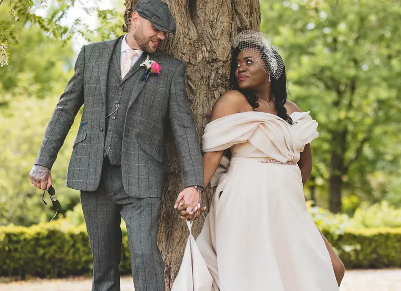 Bride and groom walking hand in hand during natural outdoor wedding photography