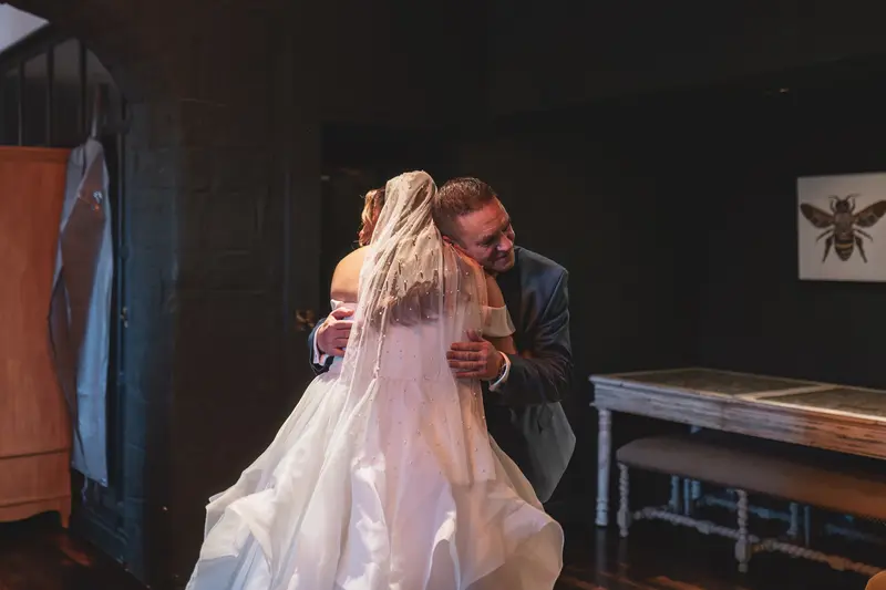 Bride sharing an emotional hug with her father before the wedding ceremony