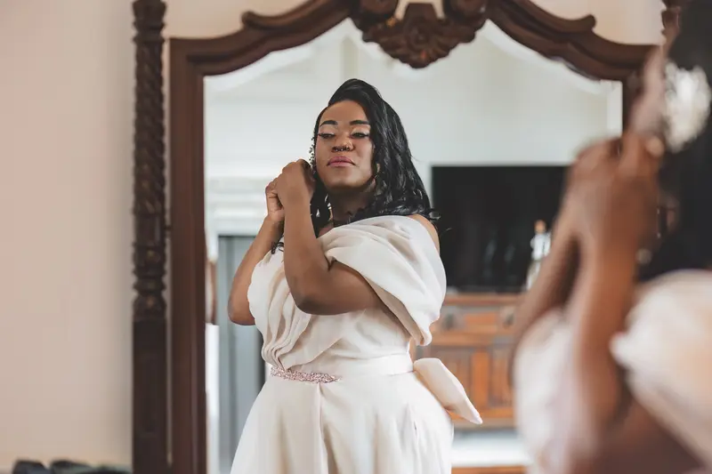 Bride applying perfume during elegant bridal preparations before the ceremony