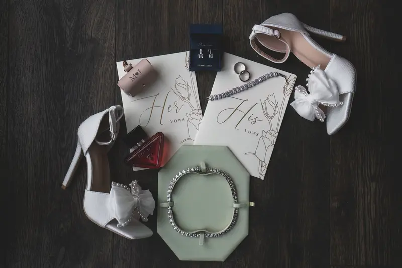 Luxury bridal flat lay with wedding shoes, vows booklets and jewellery, bridal details photography
