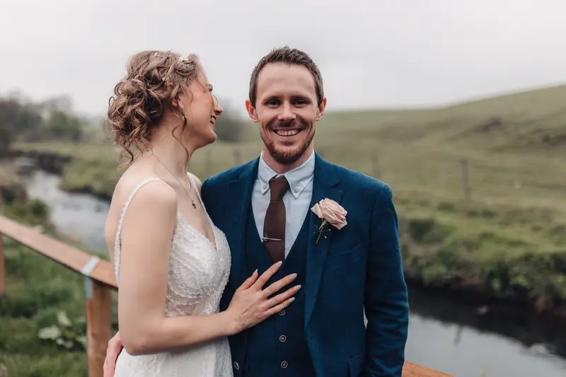 Natural smiling groom portrait with bride during relaxed outdoor wedding session