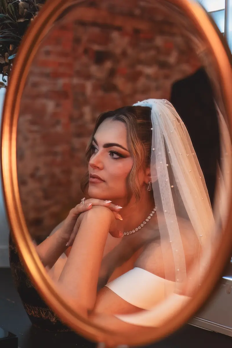 Close up bridal portrait reflected in a mirror during luxury wedding morning preparations