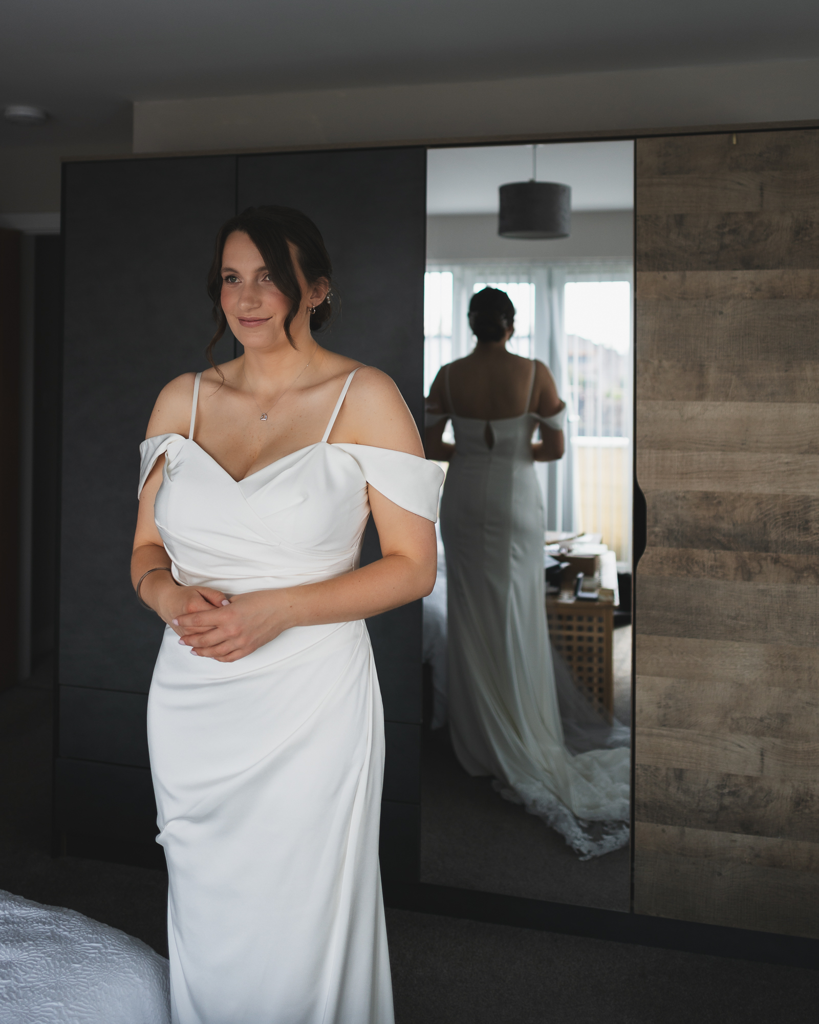 Elegant bridal portrait during wedding preparations with mirror reflection in modern Yorkshire bridal suite
