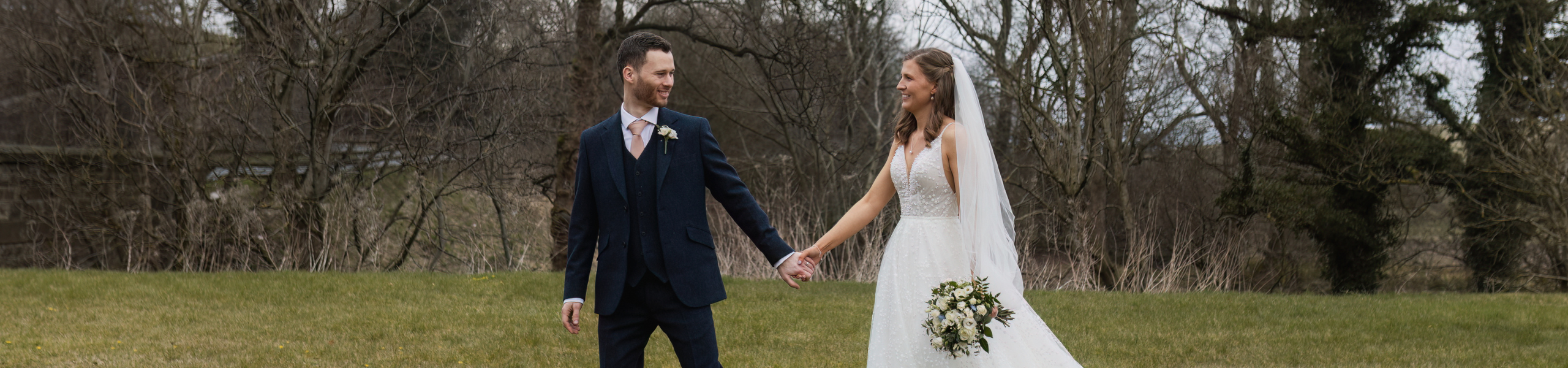 Bride and groom walking outdoors during a Leeds wedding