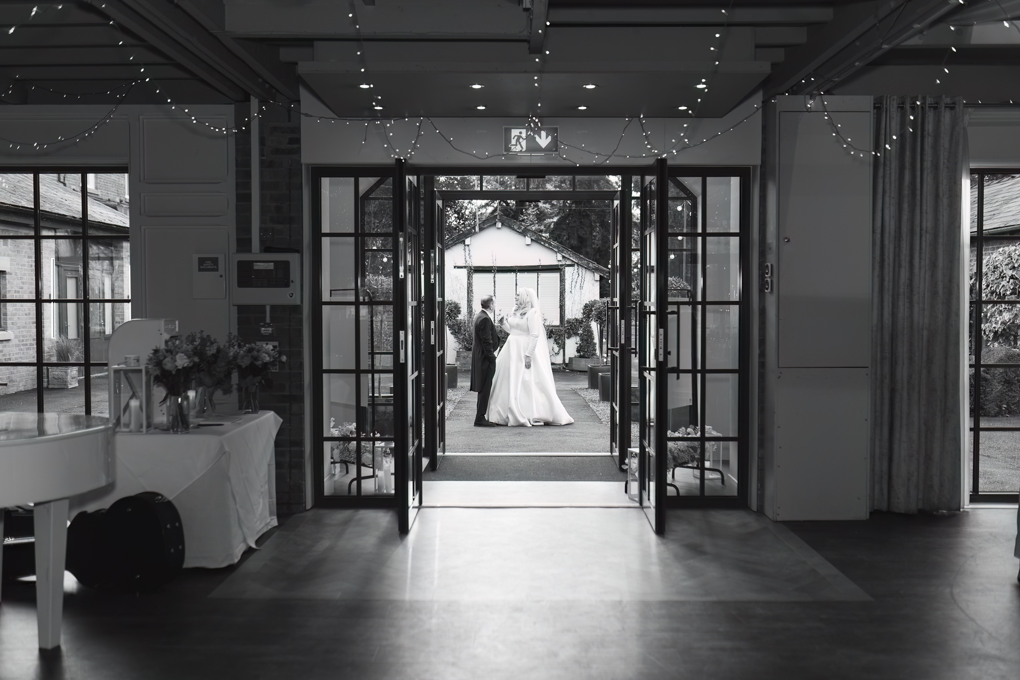 Bride and groom in cowboy hats sharing a kiss during a rustic Yorkshire barn wedding.